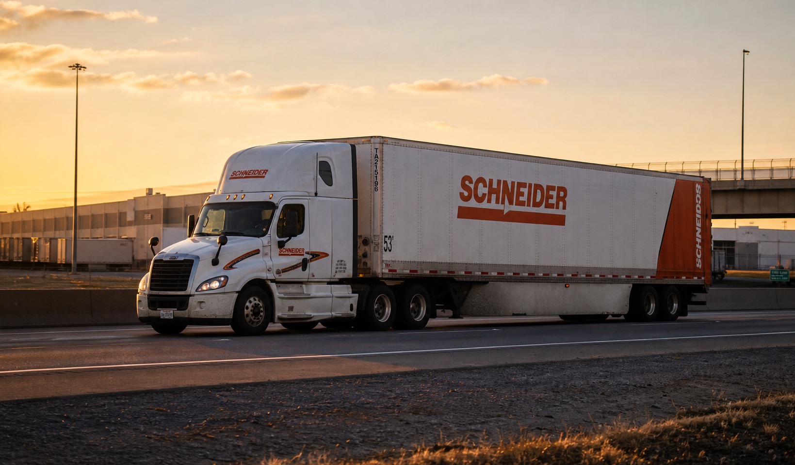Schneider truckload trailer moving on a highway at sunset